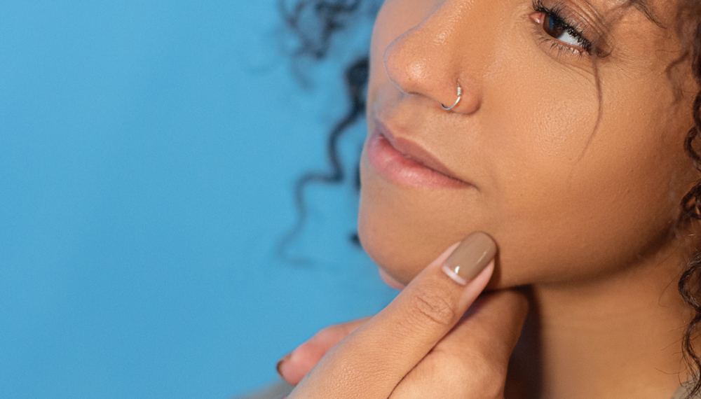 Hand on a woman's jaw.